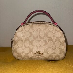 Pink ish coach clutch